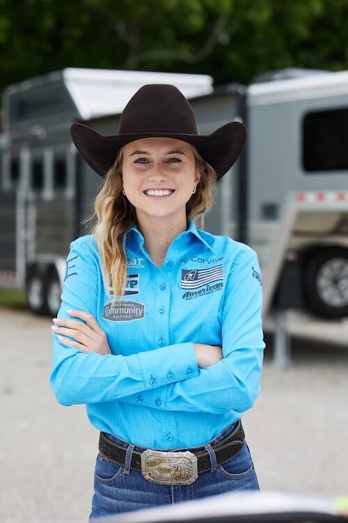 A portrait of Josie Conner with a trailer in the background