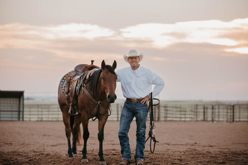 Phil Haugen standing next to a horse