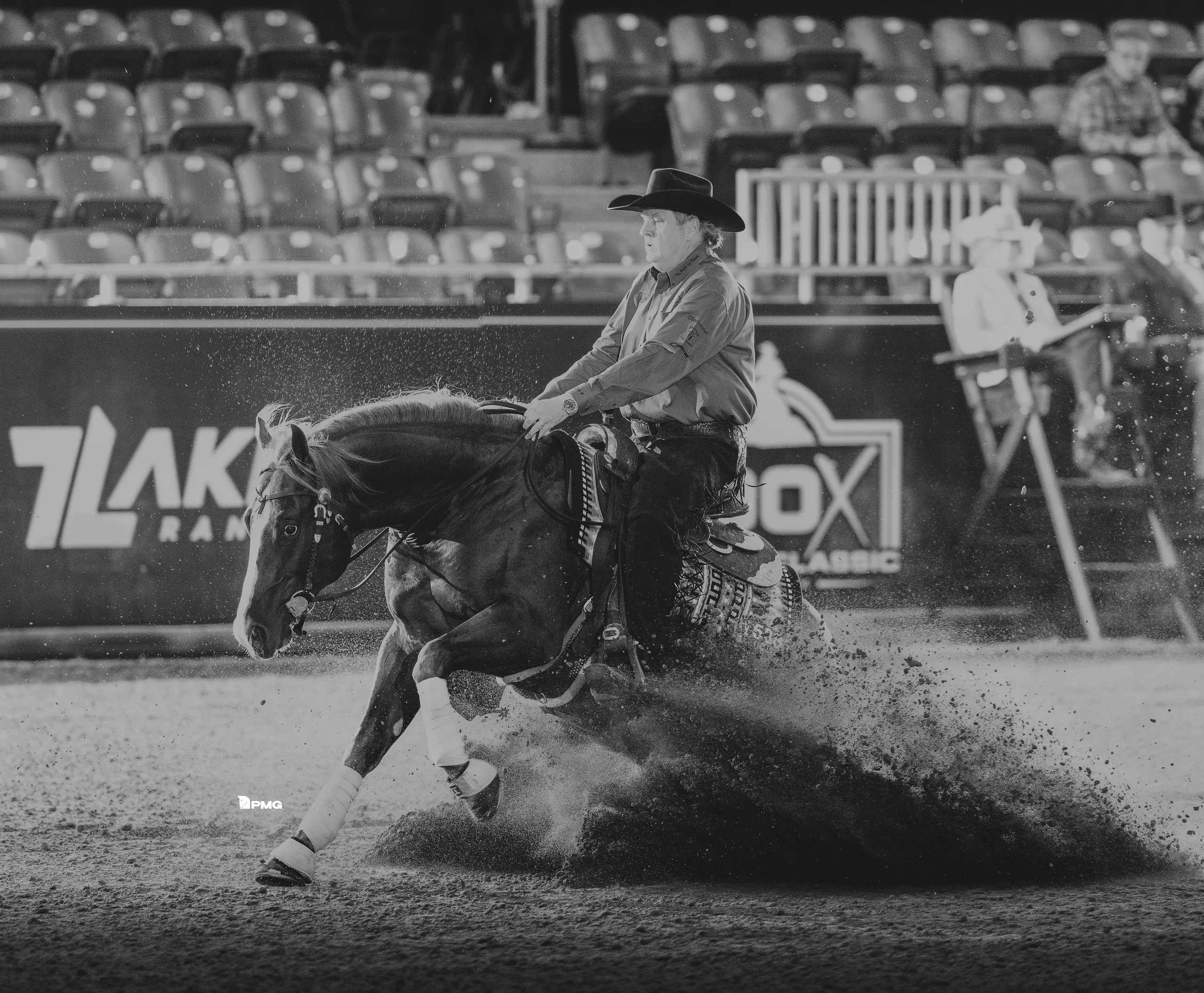 Tom McCutchgeon atop a horse sliding in the dirt