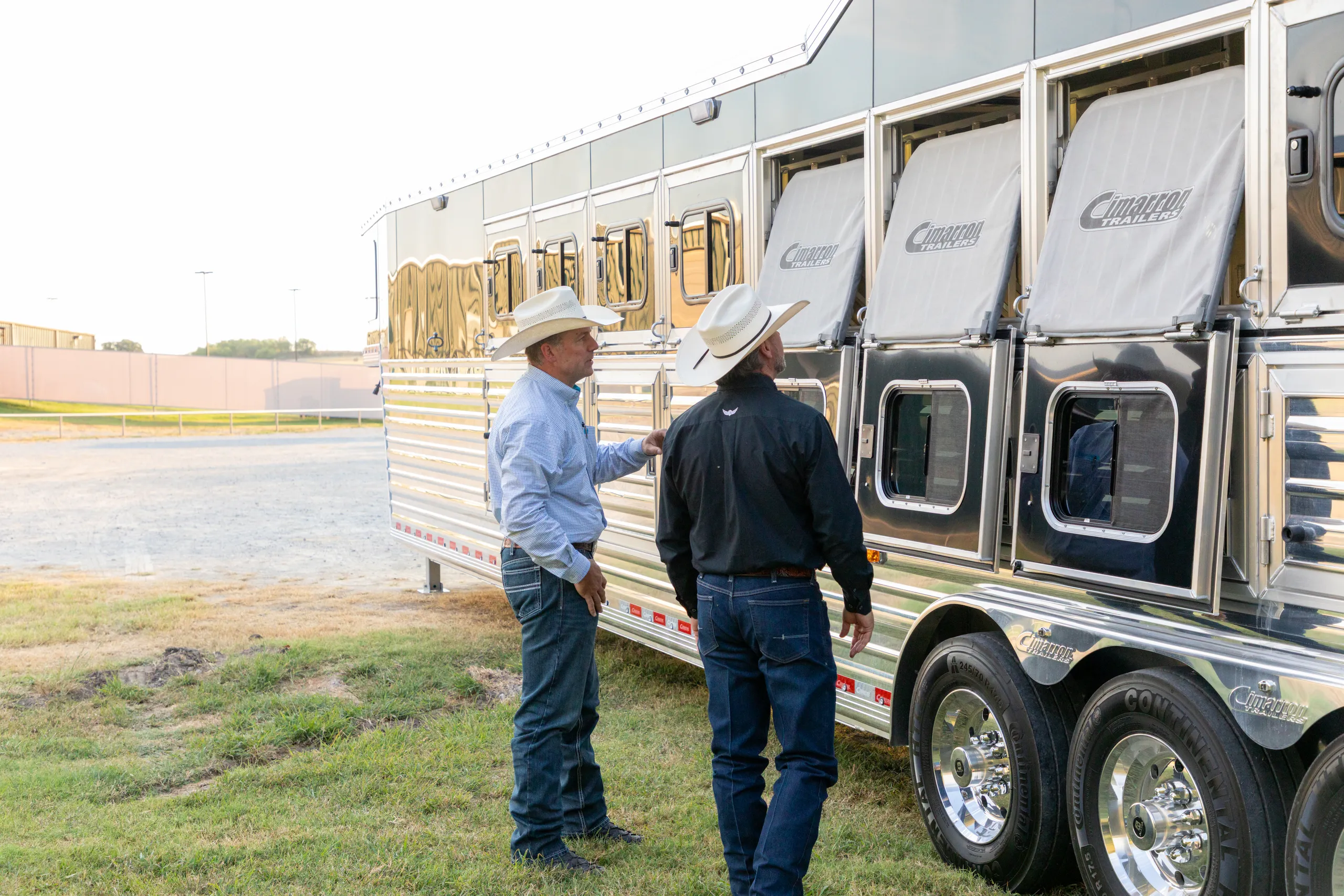 Trevor Brazile inspecting a large horse trailer