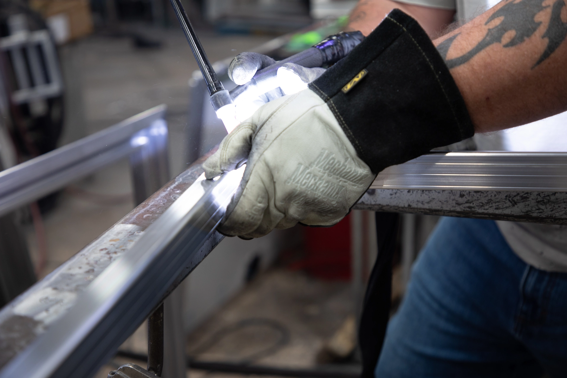 Close-up of a hand welding a metal frame