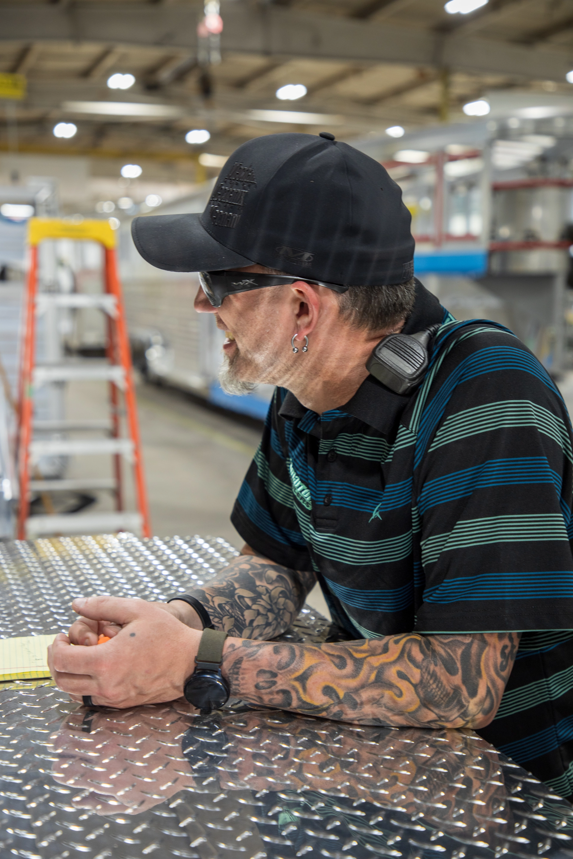 A tattooed Cimarron employee smiling